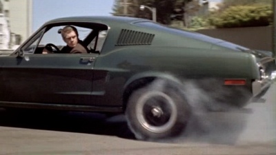 Steve McQueen is reversing his Mustang at
speed; smoke is pouring from the tyres.